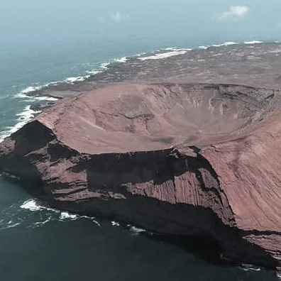 Aerial view of a volcanic crater on the coast